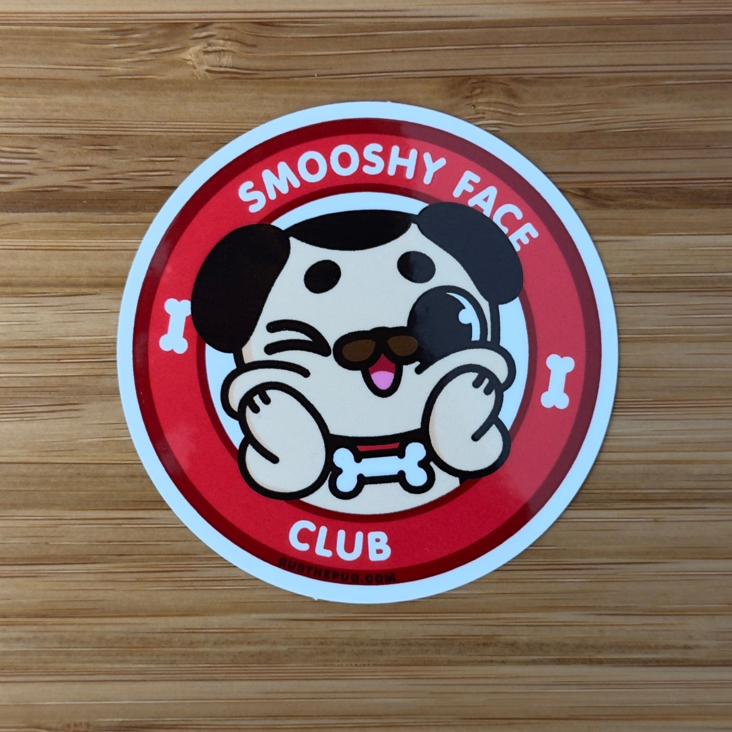Sticker with a cartoon dog design on a wooden surface