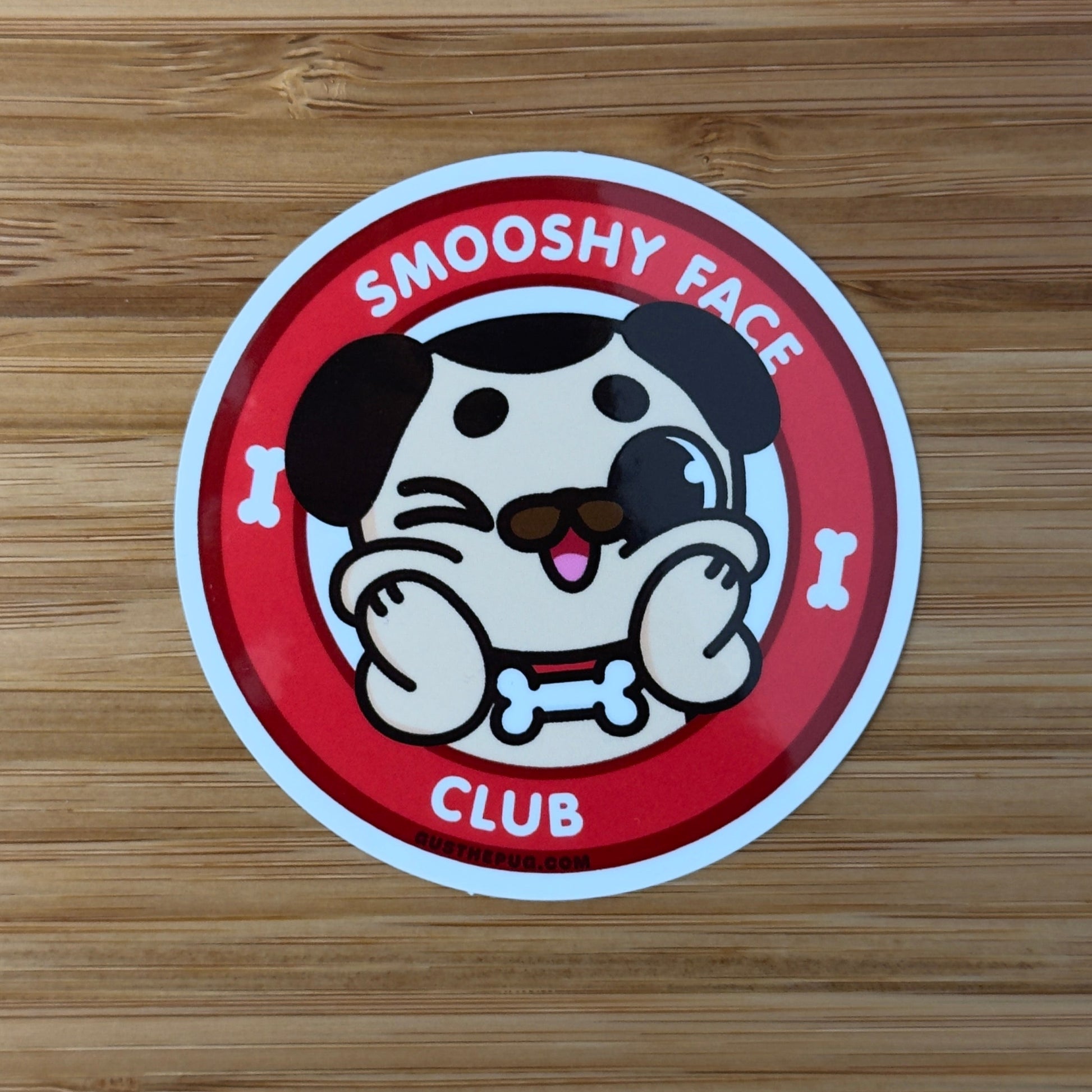 Sticker with a cartoon dog design on a wooden surface
